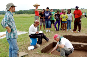 Archaeologists and students at a dig