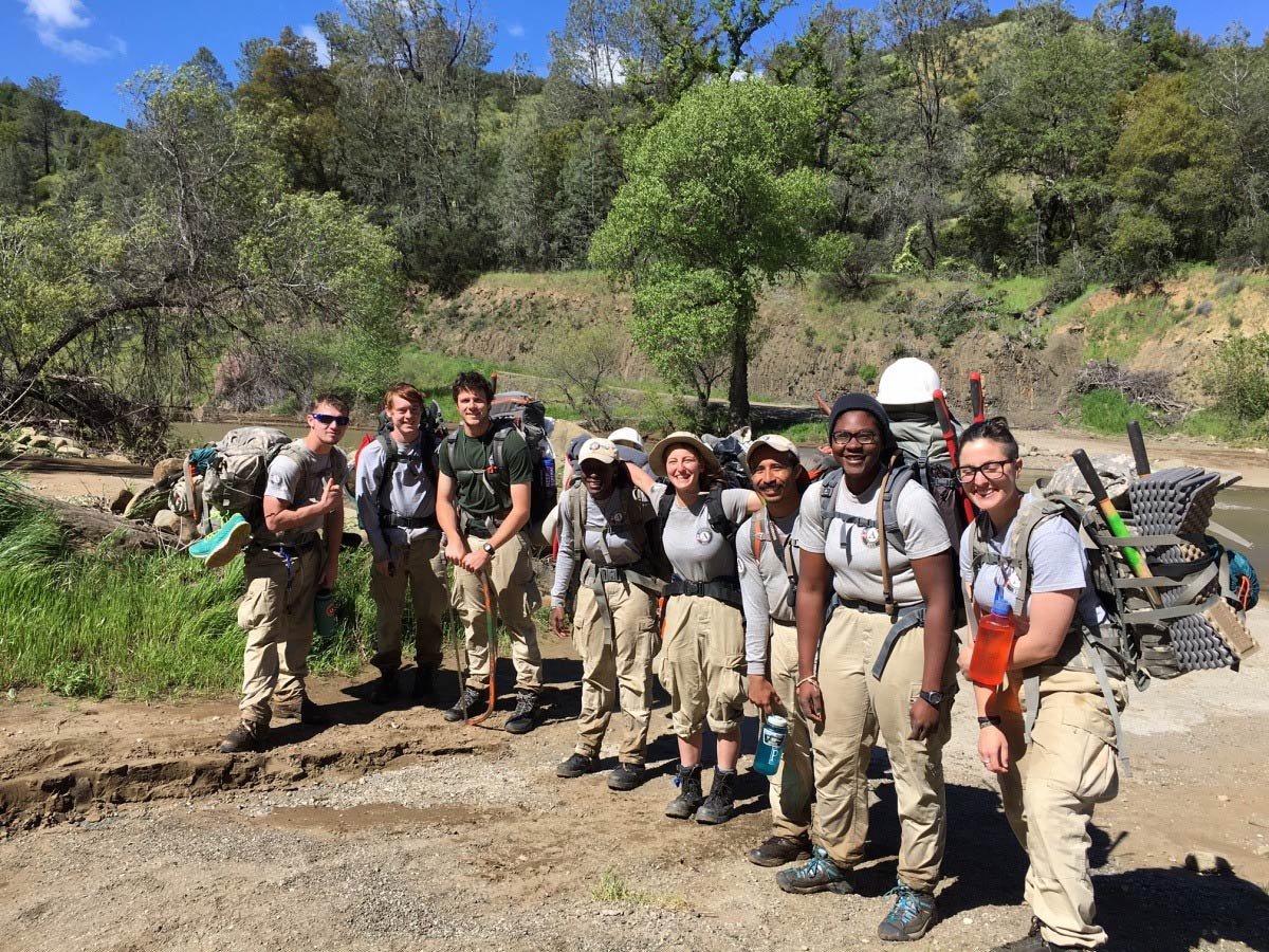Americorps volunteers in a line with backpacks